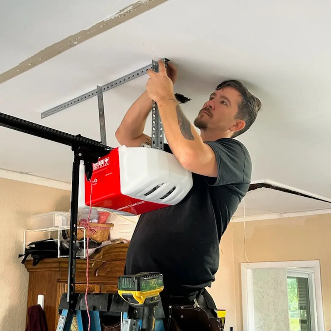 technician repairing garage door opener