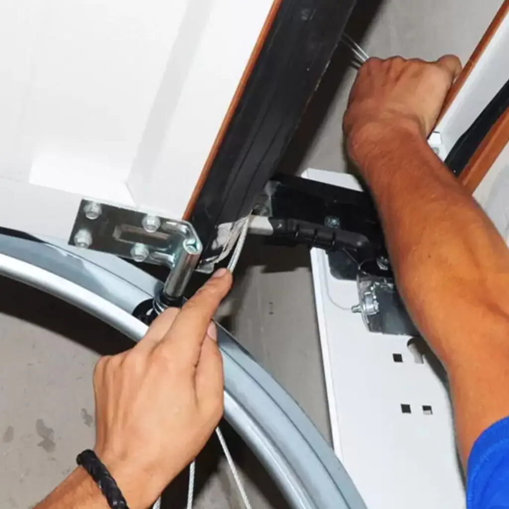 technician repairing interior garage door roller repair