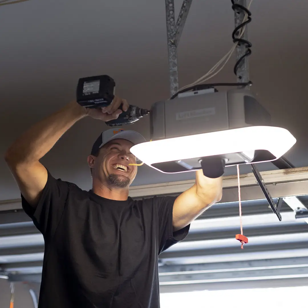 technician repairing modern garage door opener